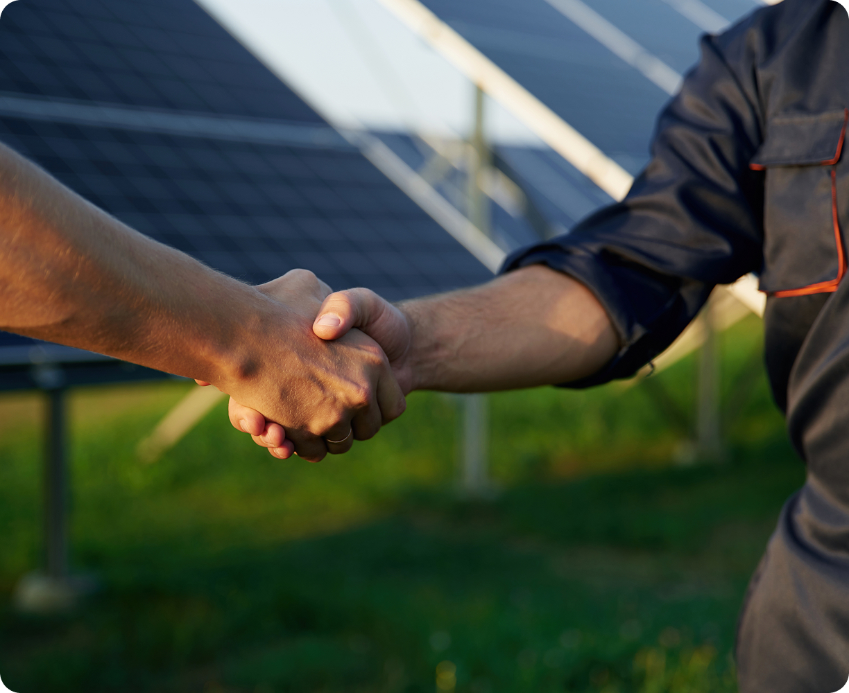 close-up-view-handshake-against-solar-panels-outdoors