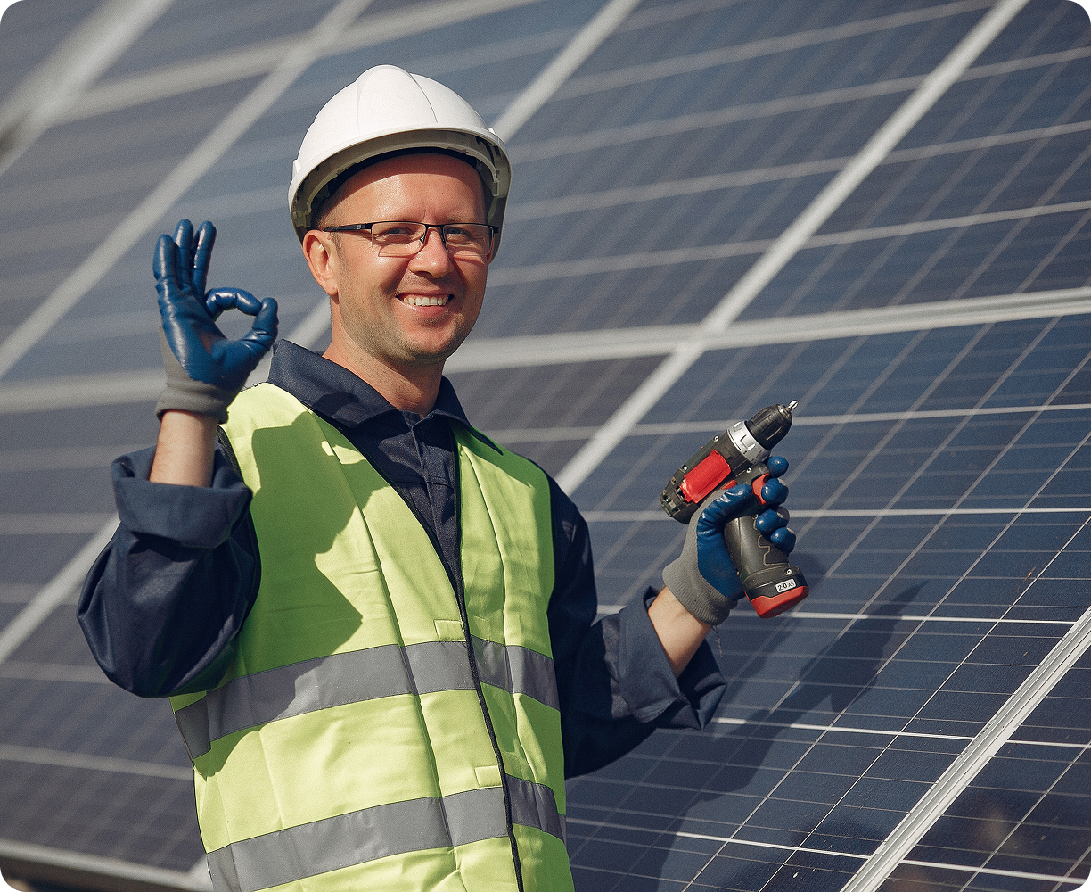 man-with-white-helmet-near-solar-panel