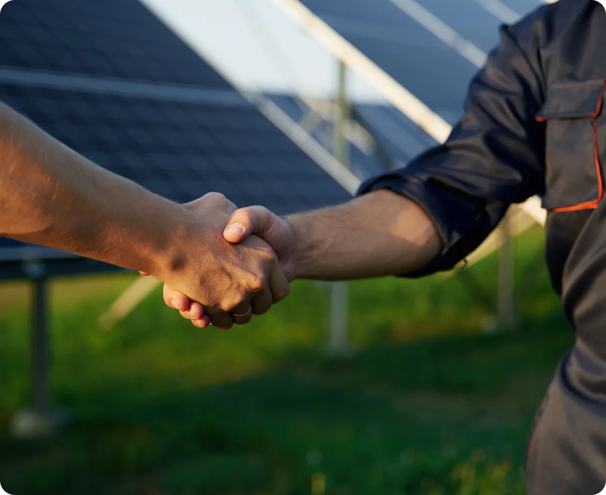 close-up-view-handshake-against-solar-panels-outdoors